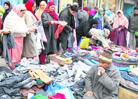 People throng a market in Srinagar to buy woollens as the city witnessed yet another day of severe cold on Monday