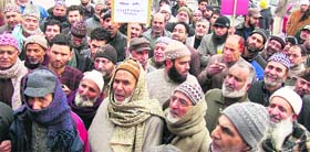 Intending Haj pilgrims, who were duped by a travelling agency, hold a protest in Srinagar on Monday