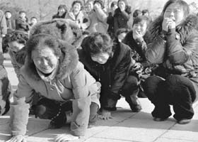 North Korean women mourn the death of their leader in Pyongyang on Monday