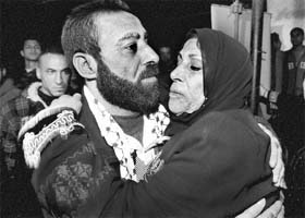 A Palestinian prisoner hugs his mother after his release at Shati refugee camp in Gaza City on Sunday