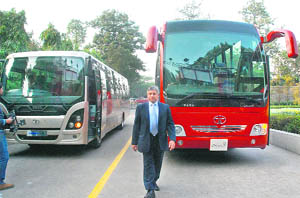 Ravi Pisharody (L), president of Tata Motors commercial vehicles business unit, poses with the Tata Divo and Tata Starbus Ultra bus models at their launch in New Delhi on Tuesday. The company said the new variants would compete with the likes of Volvo and Mercedes. 