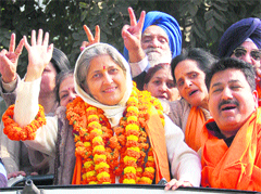 SAD councillor Harjinder Kaur waves out to her supporters after her win in the MC elections in Chandigarh