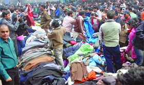 People throng Janpath Market to buy woollen clothes as the temparature dips in New Delhi on Tuesday.
