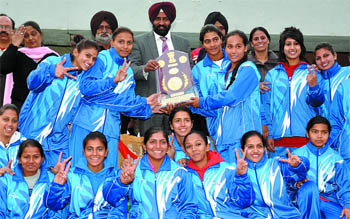 The overall winners of 37th Women National Games pose with the trophy at Olympian Surjit Hockey Stadium in Jalandhar on Tuesday. 