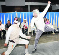  A fencer in an effort to attain full points against his opponent during the Inter-College Fencing Tournament in Chandigarh 