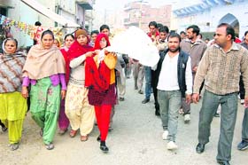 Sonia of Ramganj Mohalla in Bhiwani carries her father Brij Lals body for cremation on Wednesday