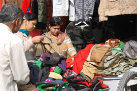 Customers choose woollen clothes at a shop in the city on Thursday. 
