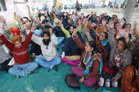 Multi-purpose health workers raising slogans against the state government for not accepting their demands, near the Blood Bank at the Civil Hospital in Bathinda on Thursday. 