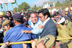 Congress MLA GS Bali along with party workers stage a protest near the Vidhan Sabha in Dharamsala on Thursday.