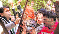Members of the Bar Association protest outside the residence of Deputy Chief Minister Tara Chand in support of their demands in Jammu on Thursday.