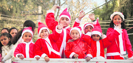 Children dressed as Santa Claus take part in a procession to celebrate Christmas in Jammu on Thursday.