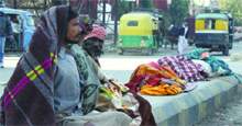 Beggars exposed to extreme cold conditions in Jalandhar on Thursday.