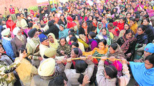 ASHA workers in confrontation with policemen in Ludhiana on Thursday. 