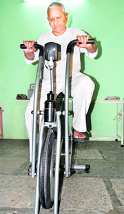 Anna Hazare works out on an exercise cycle in Ralegan Siddhi in Ahmednagar on Thursday.