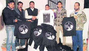 Activists of a political group show pro-Khalistan T-shirts seized by the police in Ludhiana on Wednesday. 