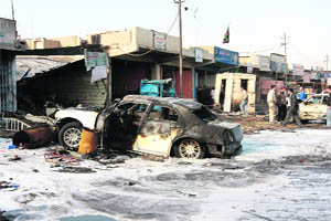 A burnt vehicle seen after a bomb attack took place in Baghdads Bayaa district on Thursday. 