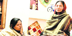 Malti Devi (left), mother of Gaurang and Kavita who were found murdered a few days ago, breaks down at her flat in Sector 41, Chandigarh, on Friday. Her mother is also seen in the picture.