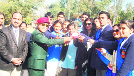 Brigadier SK Thapa gives away the overall trophy to the Gandhi House of Army School, Clement Town, Dehradun on Friday.