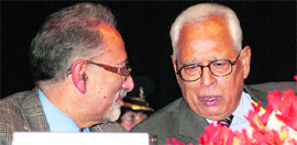 Governor NN Vohra speaks to MS Pandit, chairman of the ASCENT group, during a function in Jammu on Friday.