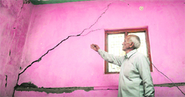 Cracks in the wall of one of the houses in Sabbar village.