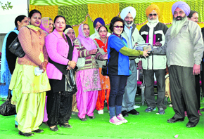 Volunteers of the Young Sikhs Association Singapore with villagers at Assi Kalan on Thursday. 