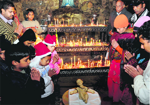 Midnight Christmas prayers being offered at Catholic Church, Sector 19, Chandigarh, on Saturday.