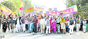Farmers from villages of the Rai and Kundli region march against the acquisition of their land, on the GT Road on Saturday