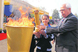 Governor NN Vohra lights up a ceremonial sports torch during a function at Heritage School in Jammu on Saturday