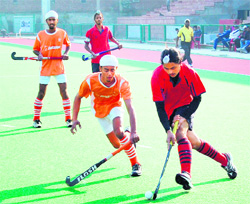 Players of Namdhari Academy and Baba Uttam Singh Hockey Academy in action during ONGC Ninth All India Maharaja Ranjit Singh Junior Gold Cup Hockey tournament in Amritsar on Sunday. 