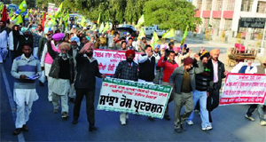 Members of various organisation hold a joint protest march against the SAD-BJP government, in Bathinda on Sunday.