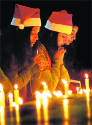 Devotees light candles on Christmas at Catholic Church in Sector 19 of Chandigarh on Sunday.