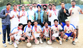 Players of the handball team of DAV College, Sector 10, strike a pose with their medals in Chandigarh on Sunday. 