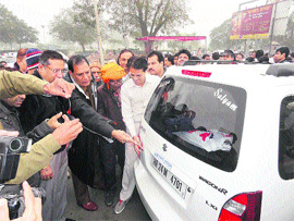 Devender Yadav, SP, installs a reflector on a car in Sirsa . 