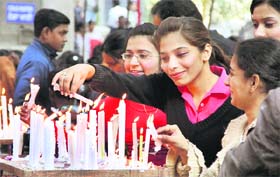 Visitors at the Catholic Church light up candles on Christmas in Jalandhar on Sunday