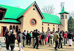 People gather in a Catholic Church in Srinagar on Sunday