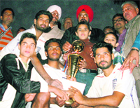 Winners receive trophy at the Sixth RS Football tournament at Gandhi School on Sunday. 