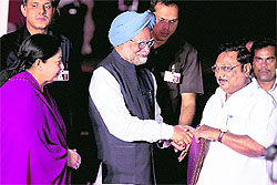 Prime Minister Manmohan Singh being welcomed by Union Chemicals and Fertilisers Minister MK Azhagiri as Tamil Nadu Chief Minister J Jayalalithaa looks on at the Chennai airport on Sunday