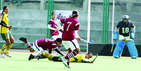 Women players of Khadoor Sahib Academy and Khalsa College For Women fight it out during the ONGC All-India Maharaja Ranjit Singh Junior Gold Cup Hockey Tournament in Amritsar on Monday.