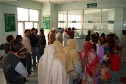 Patients queue up at the registration counter in the Civil Hospital to get OPD slips, in Bathinda on Monday. 