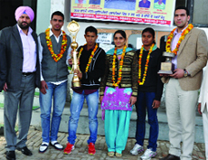 President of the District Athletics Association KPS Brar (extreme left) along with the athletes of Malwa College who were honoured on Monday.
