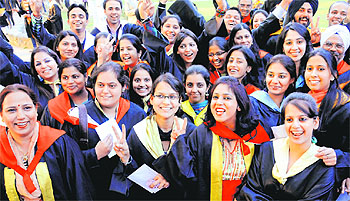 Girl students strike a pose with their certificates at the convocation. Tribune photographs