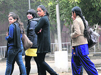 Girls brave the elements at Panjab University in Chandigarh on a chilly Monday morning. Tribune photo: Manoj Mahajan