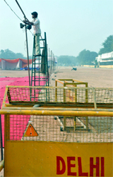 Workers put on the lights and carry mats as they ready the Ramlila Maidan on the eve of an agitation for the Lokpal Bill in New Delhi on Monday.
