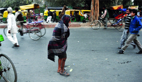 An old man covers himself with a blanket during a chilling winter morning in New Delhi on Monday.
