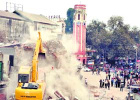 The second phase of the demolition drive under way on the Chakrata road in Dehradun on Monday