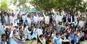 Villagers hold a dharna outside the school at Jogiwala (Sirsa) on Monday.