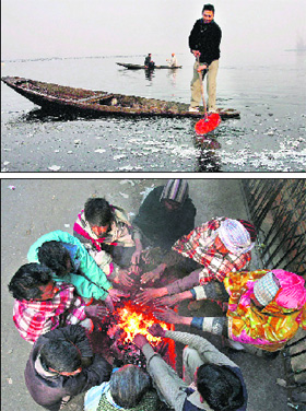(Above) A boatman breaks ice in the partially frozen Dal Lake in Srinagar.  PTI; (Below) Men warm themselves by a fire on a sidewalk in Jammu on Monday