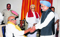 Prime Minister Manmohan Singh receives a memorandum from DMK chief M Karunanidhi at a meeting in Chennai on Monday