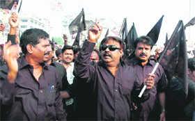 DMDK chief Vijayakant (in black glasses) and his supporters protest against the visit of Prime Minister Manmohan Singh to Tamil Nadu, in Chennai on Monday