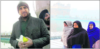 Singer-actor Gurdas Mann and women wrapped in shawls pay obesiance at the Golden Temple shrine in Amritsar on Tuesday. Photos: Sameer Sehgal